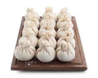 Photo of Wooden board with uncooked khinkali (dumplings) isolated on white. Georgian cuisine