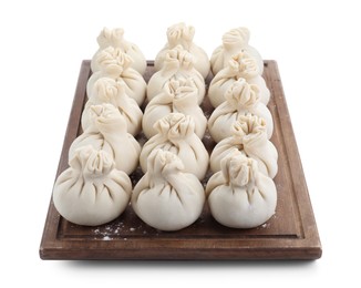 Wooden board with uncooked khinkali (dumplings) isolated on white. Georgian cuisine