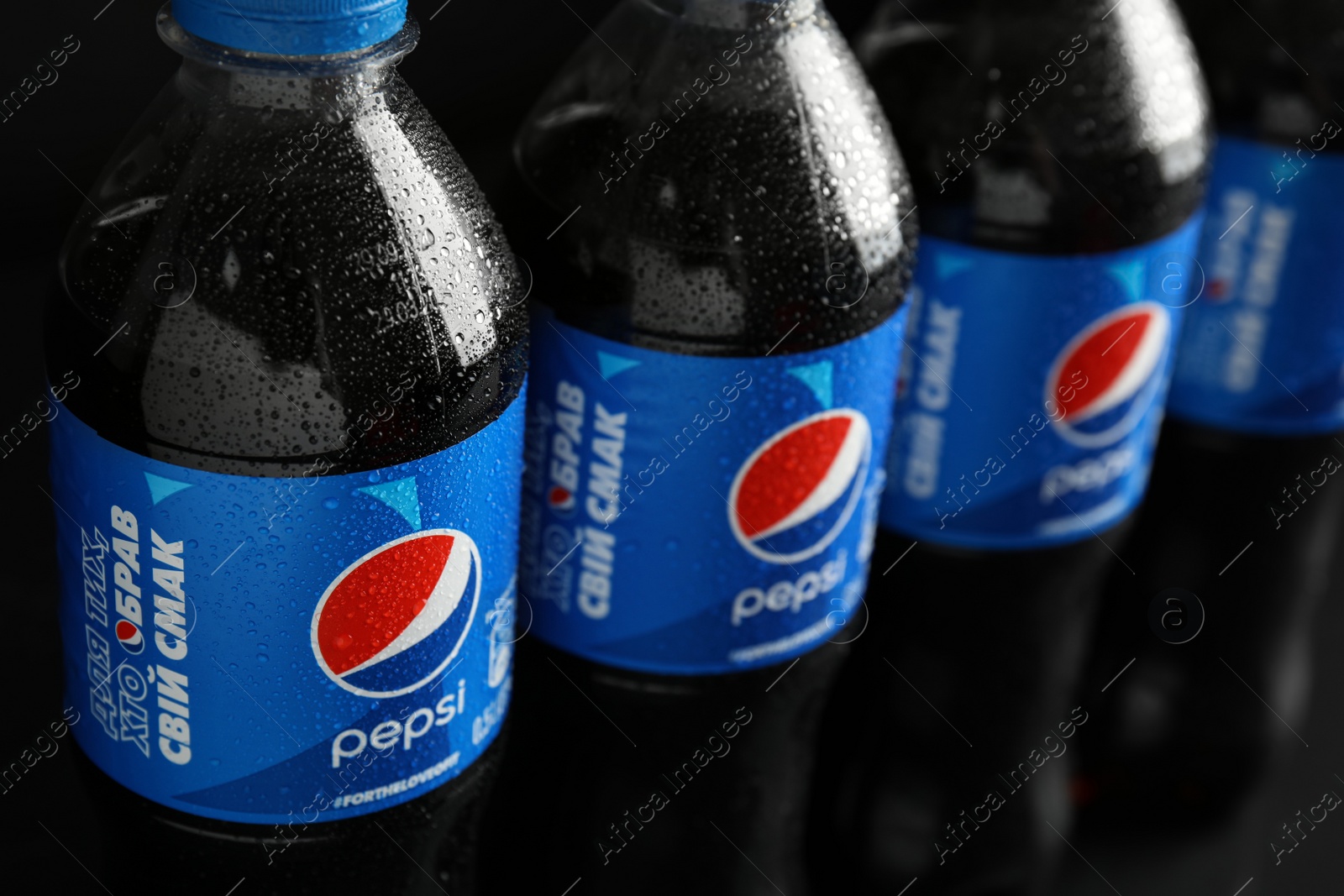 Photo of MYKOLAIV, UKRAINE - FEBRUARY 08, 2021: Plastic bottles of Pepsi with water drops, closeup