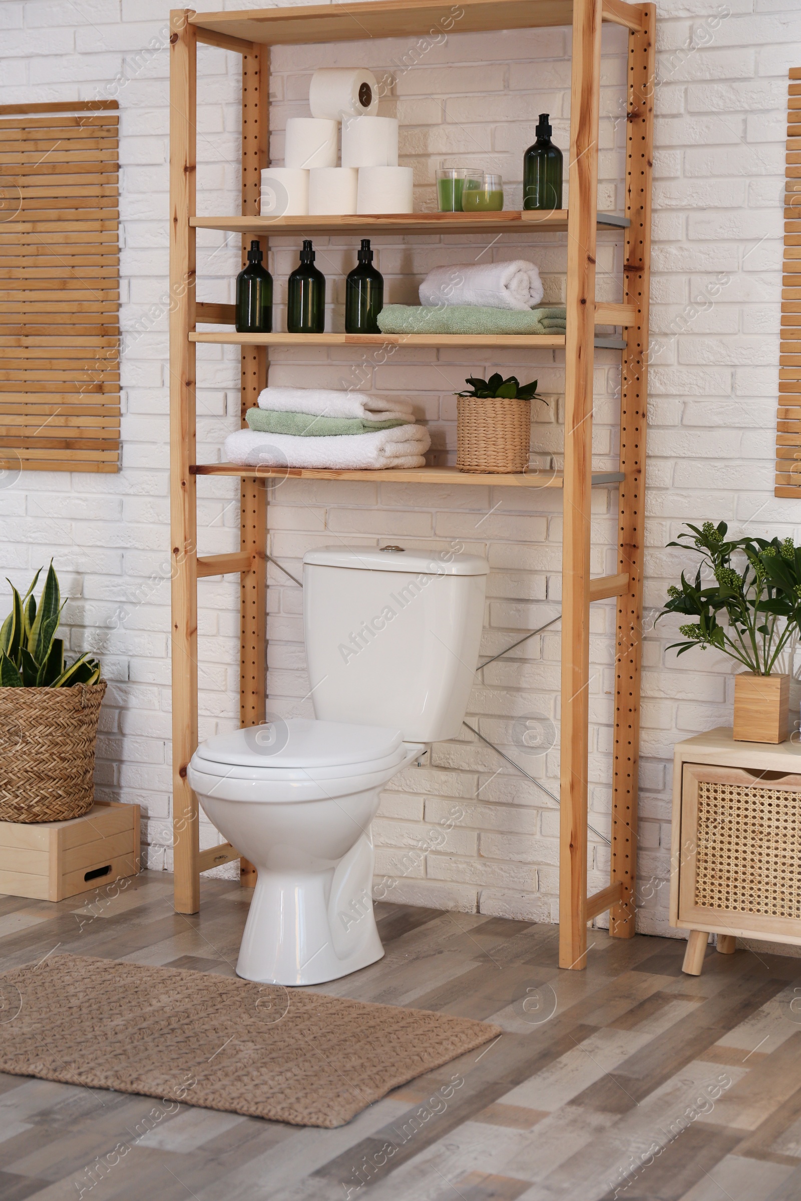 Photo of Stylish bathroom interior with toilet bowl and other essentials