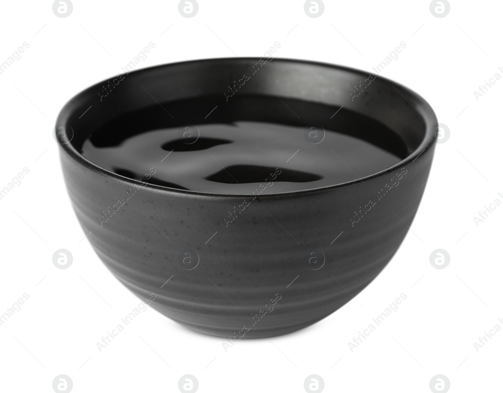 Photo of Black bowl full of water on white background