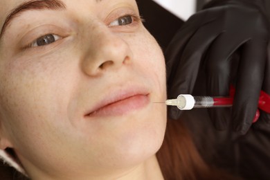 Photo of Cosmetologist giving facial injection to patient, closeup. Cosmetic surgery