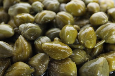 Photo of Pile of pickled capers as background, closeup view