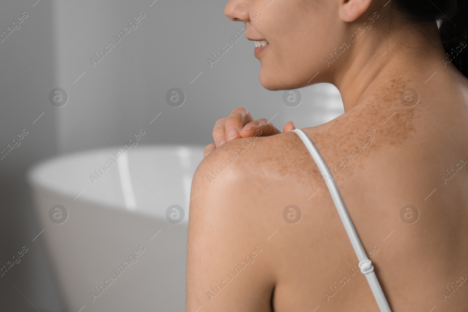 Photo of Young woman with smooth skin in bathroom, closeup and space for text. Body care