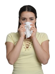 Photo of Young woman blowing nose in tissue on white background. Cold symptoms