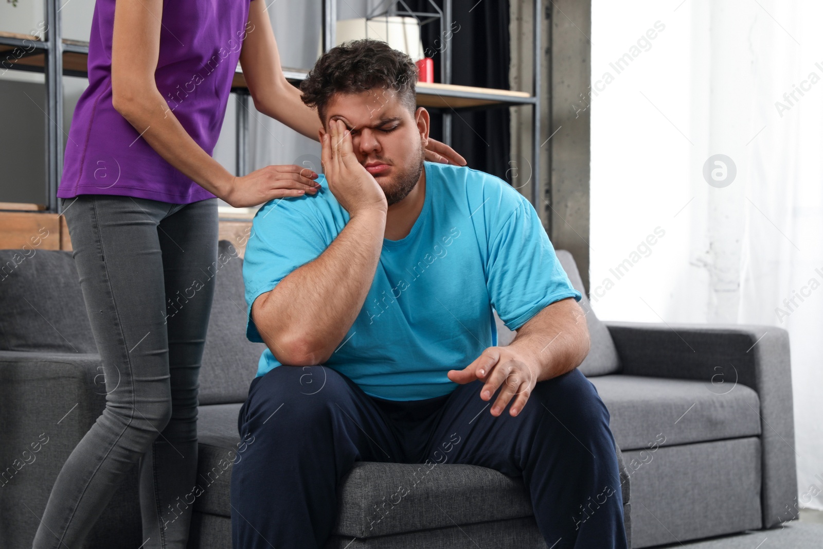 Photo of Woman comforting her depressed overweight friend at home