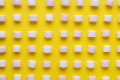 Photo of Delicious marshmallows on yellow background, flat lay