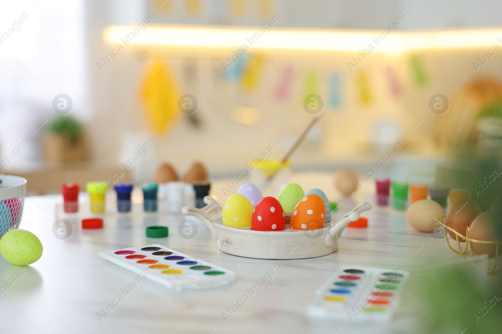 Photo of Happy Easter. Painted eggs and watercolor on white marble table indoors