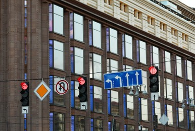 View of traffic lights and road signs in city