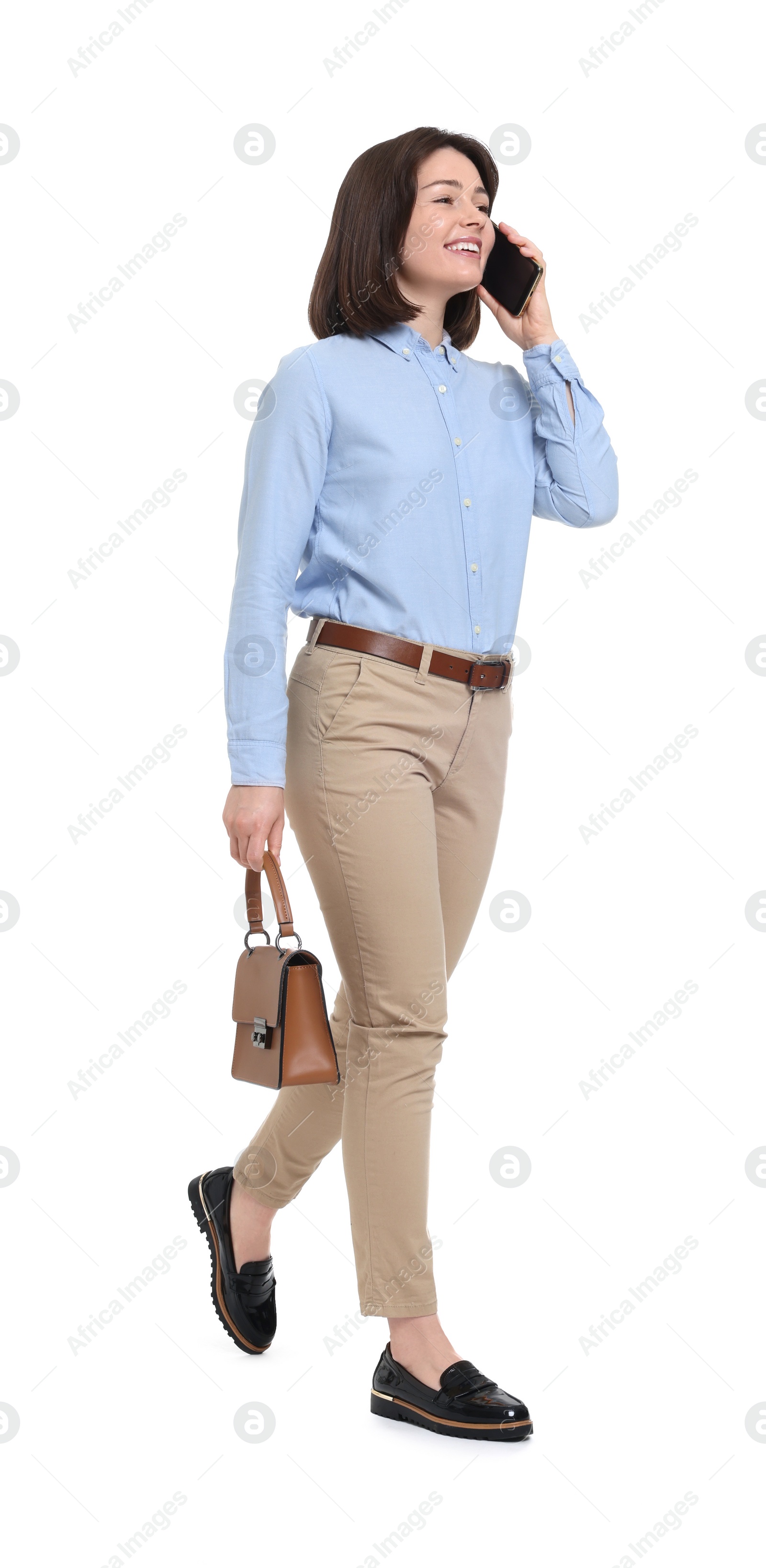 Photo of Happy woman with bag talking on smartphone against white background