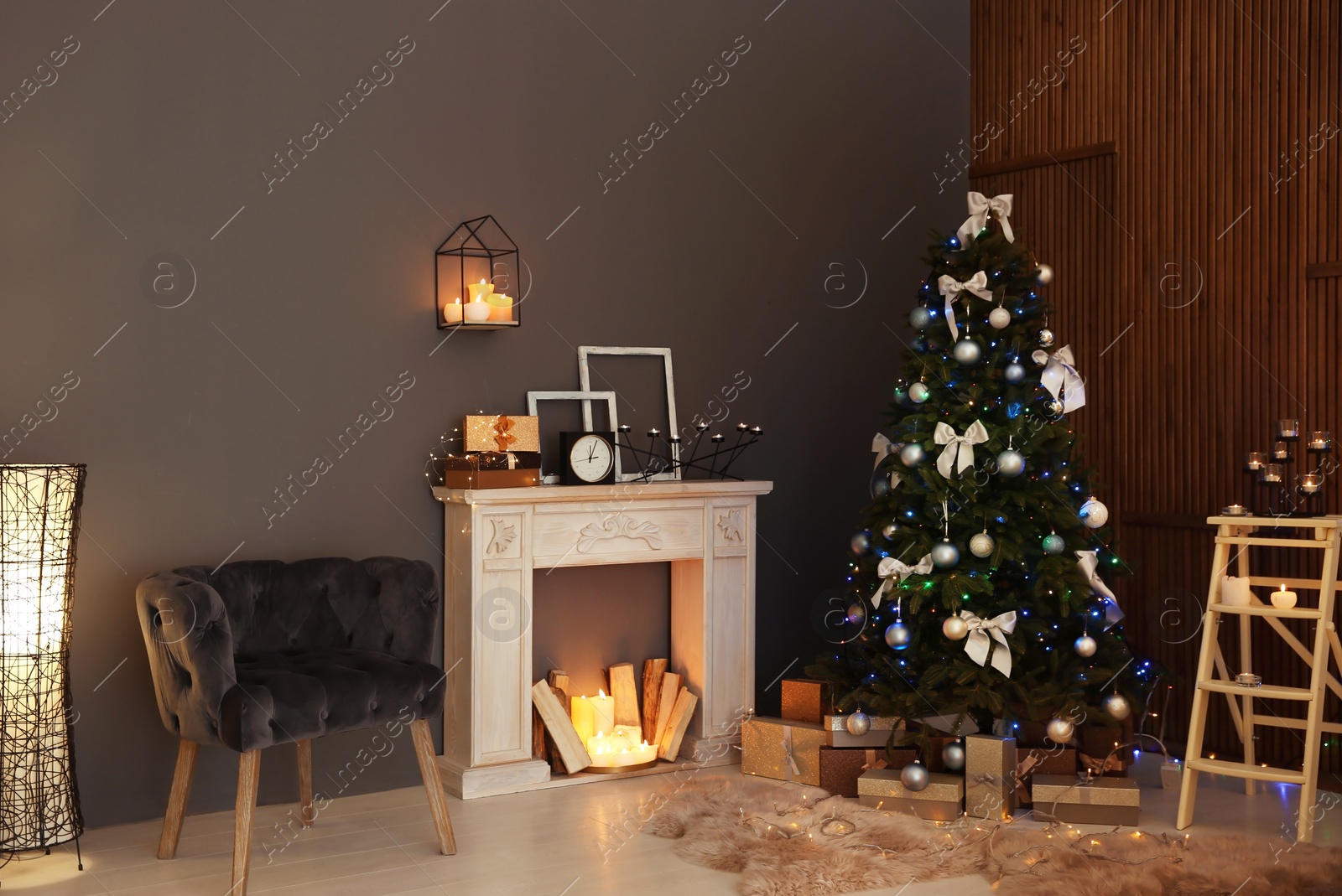 Photo of Stylish room interior with Christmas tree and decorative fireplace