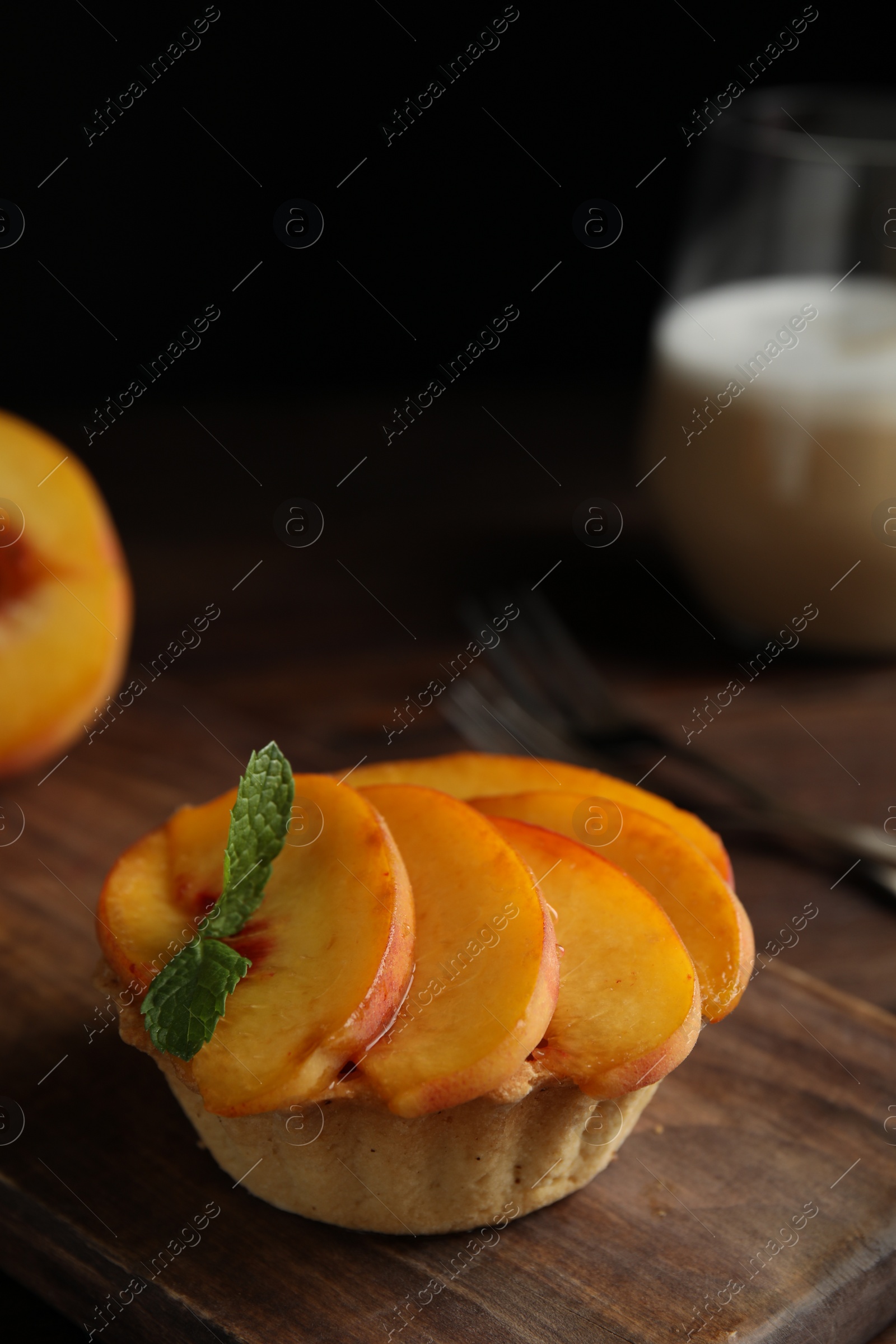 Photo of Delicious peach dessert on wooden board, closeup