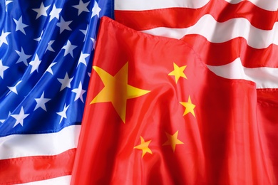 Photo of USA and China flags as background, top view. International relations