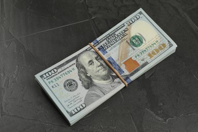 Photo of Money exchange. Dollar banknotes on dark gray textured background