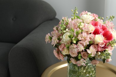 Beautiful bouquet of fresh flowers on coffee table in room, space for text