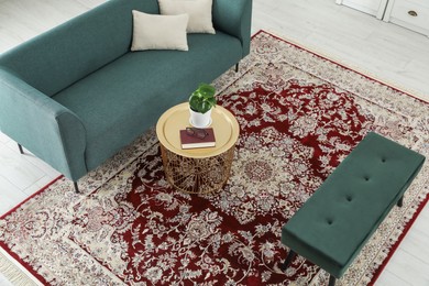 Photo of Stylish living room with beautiful carpet and furniture, above view. Interior design