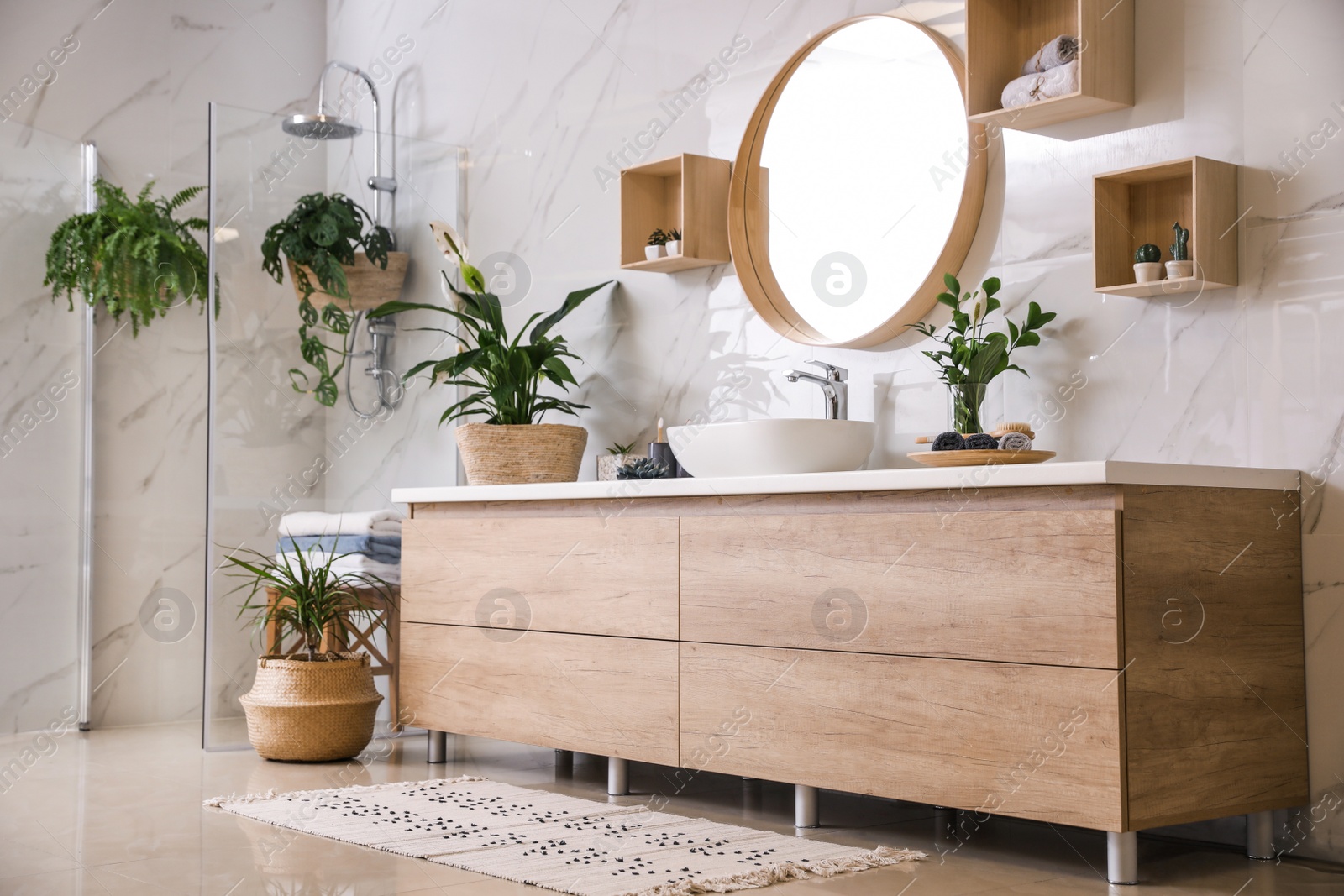 Photo of Green plants in elegant modern bathroom. Interior design