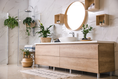 Green plants in elegant modern bathroom. Interior design