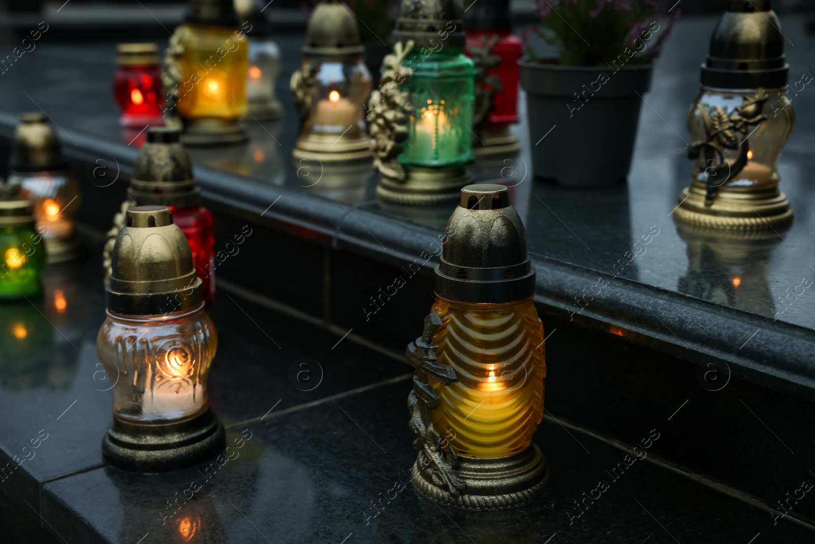 Photo of Grave lights on granite surface at cemetery