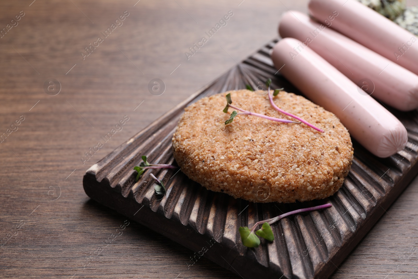 Photo of Different vegan products on wooden table, closeup. Space for text