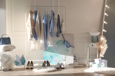 Photo of Dressing room interior with clothing rack indoors