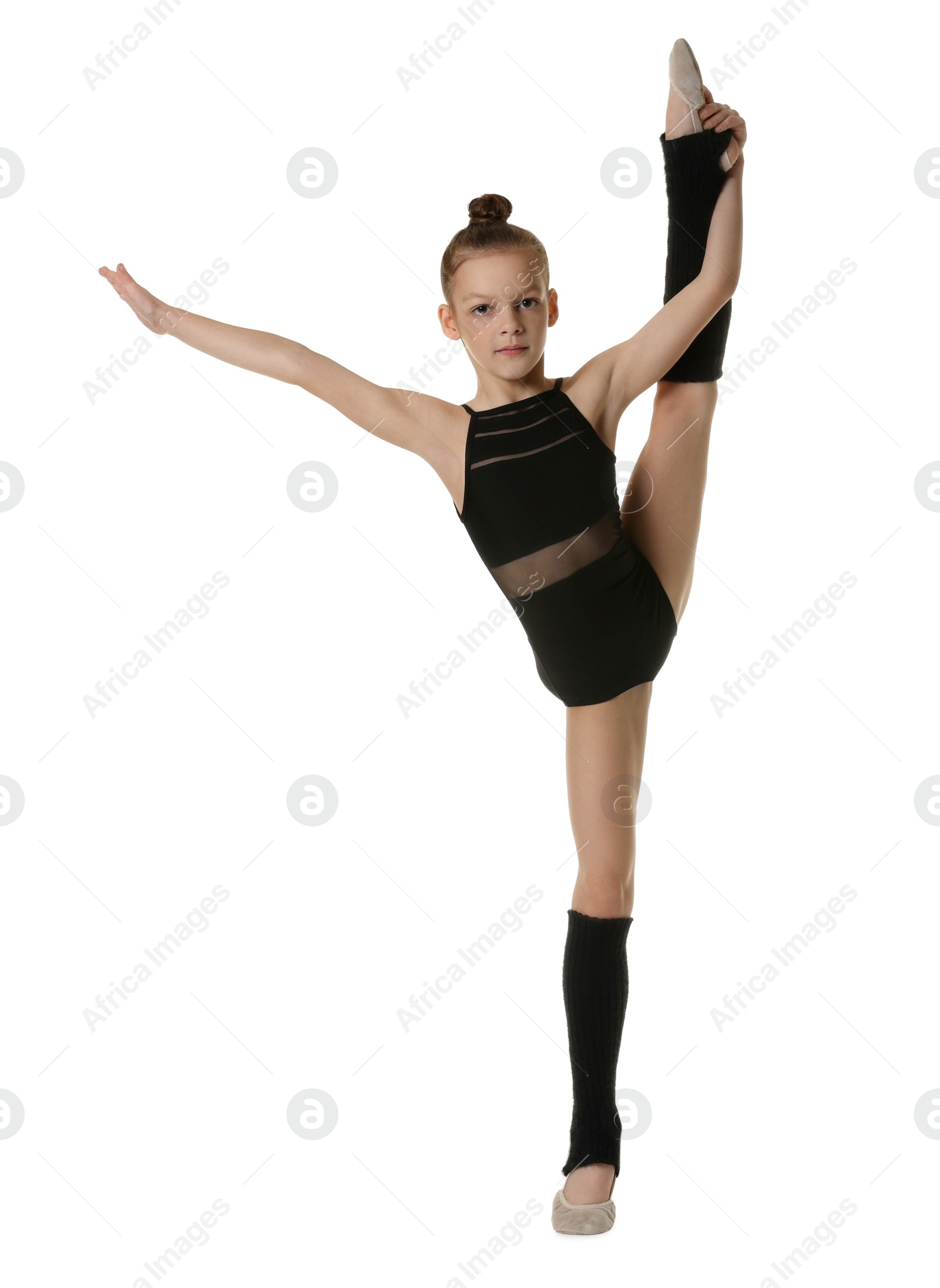 Photo of Cute little gymnast doing standing split on white background