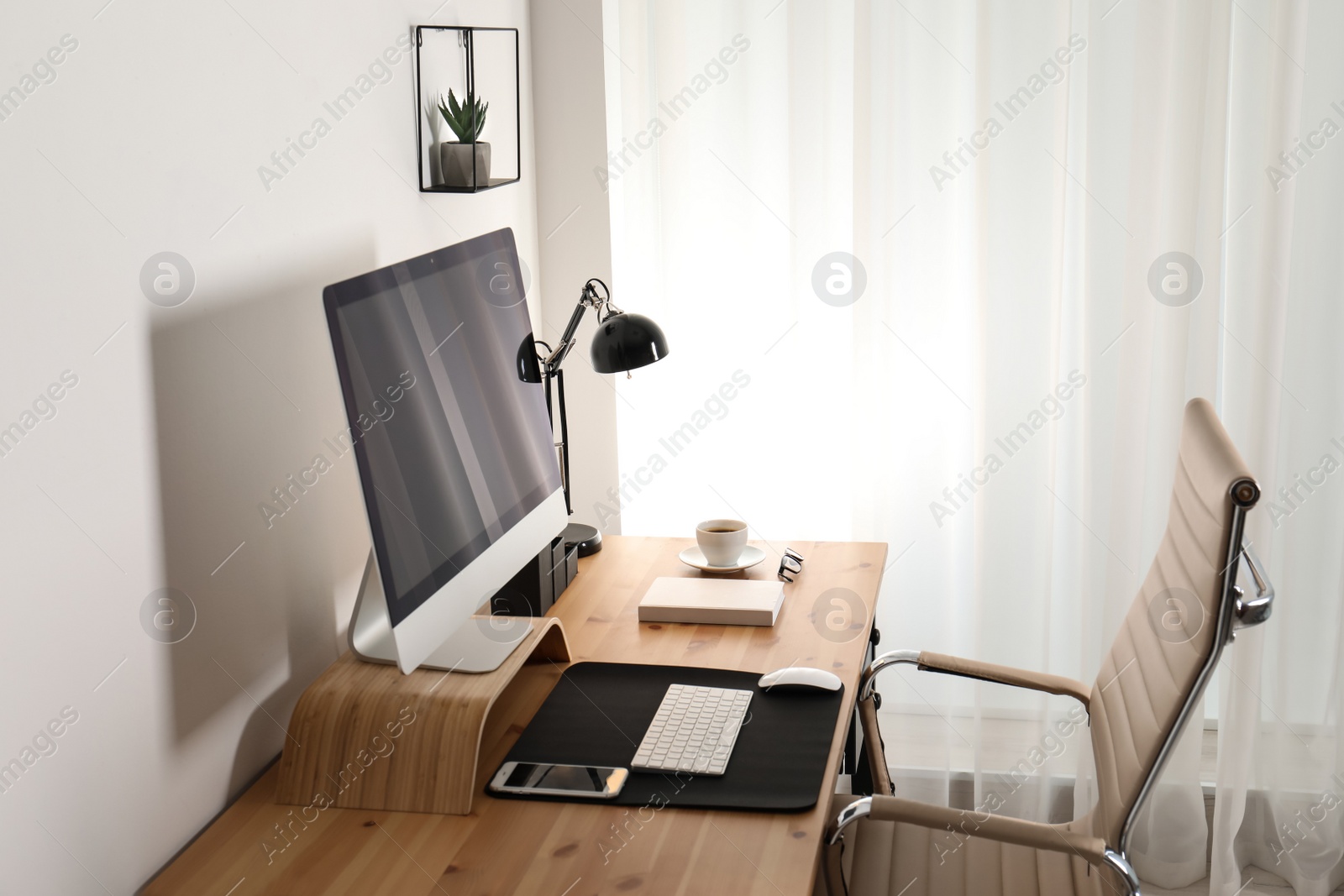 Photo of Stylish workplace interior with modern computer on table. Mockup for design