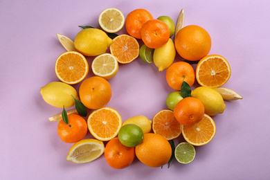 Photo of Flat lay composition with tangerines and different citrus fruits on lilac background