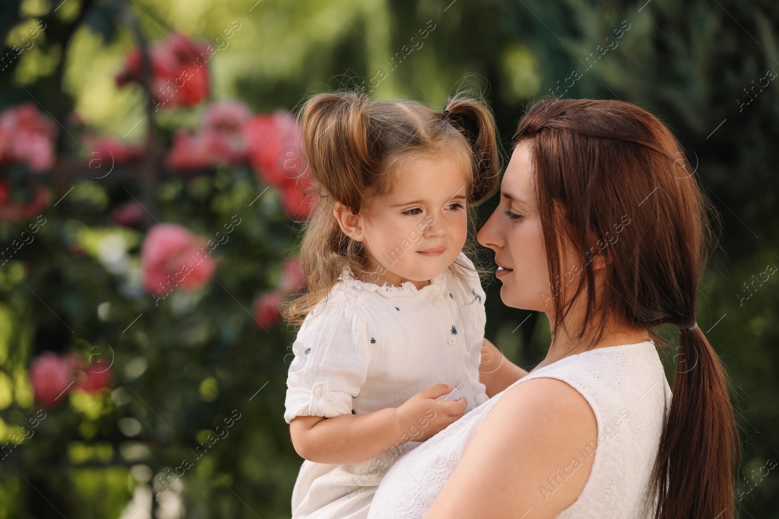 Photo of Mother with her cute daughter spending time together outdoors