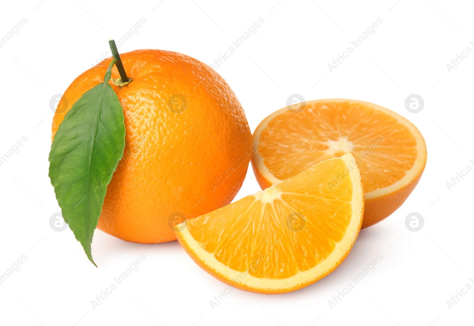 Photo of Cut and whole fresh ripe oranges with green leaf on white background