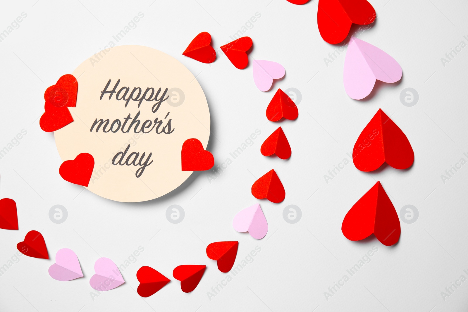 Photo of Greeting card with phrase "HAPPY MOTHER'S DAY" and paper hearts on white background