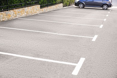 Empty outdoor parking lot with painted markings on asphalt