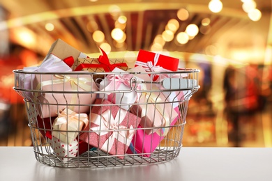 Image of Boxing day concept. Shopping basket with gifts in supermarket