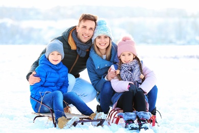 Photo of Portrait of happy family with sledge outdoors on winter day