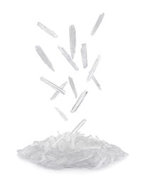 Image of Translucent menthol crystals falling into pile on white background