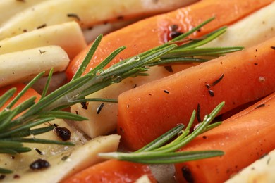 Photo of Slices of parsnip and carrot with rosemary, closeup