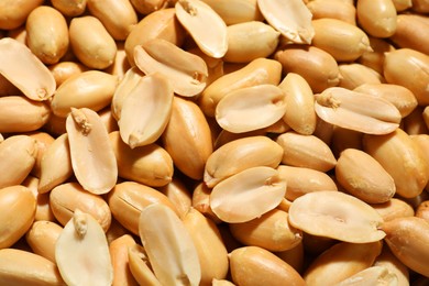 Fresh peeled peanuts as background, above view