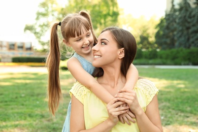 Mother with her cute child in green park on sunny day. Happy family