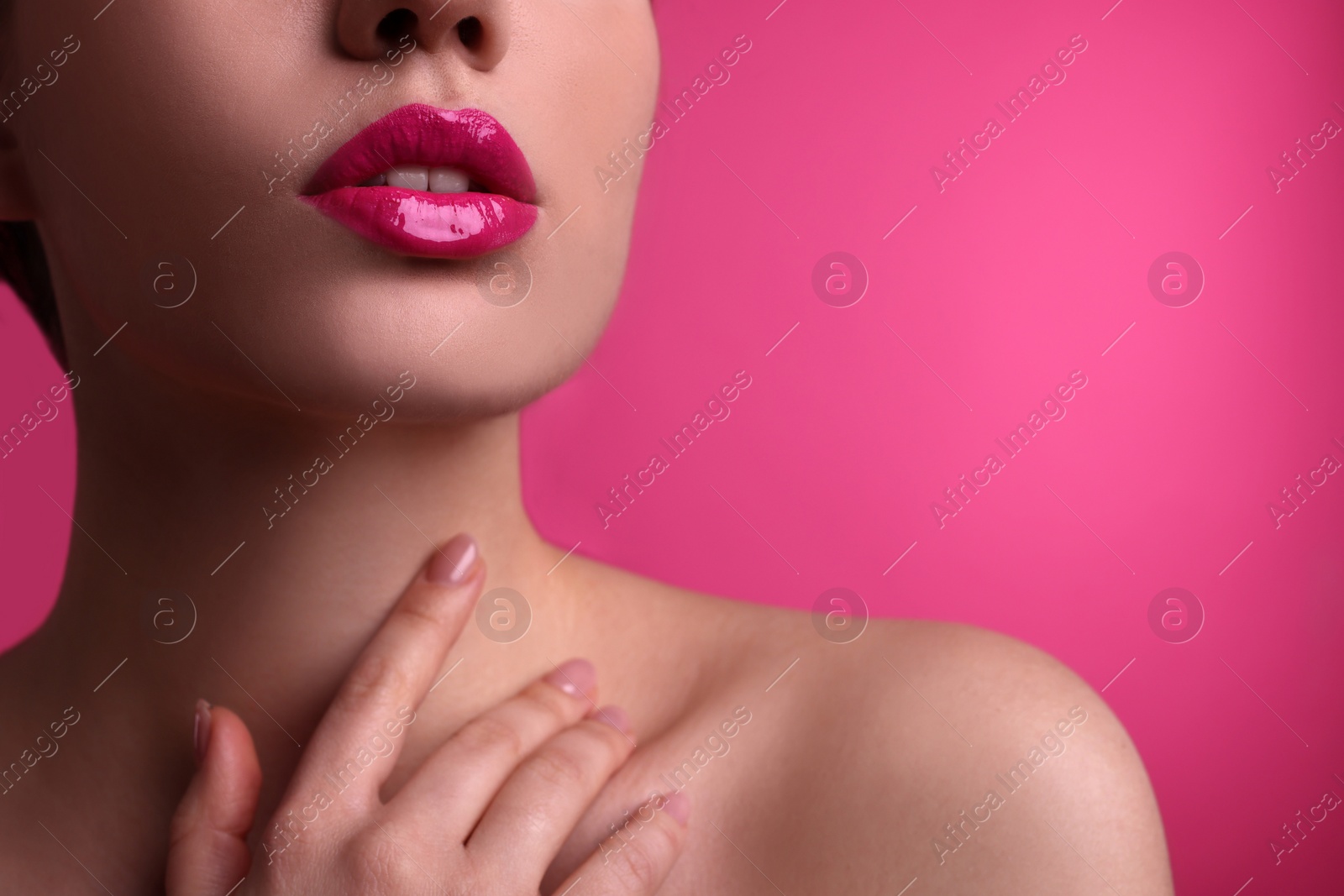 Photo of Closeup view of woman with beautiful full lips on pink background, space for text