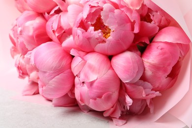 Photo of Bouquet of beautiful pink peonies on white table, closeup