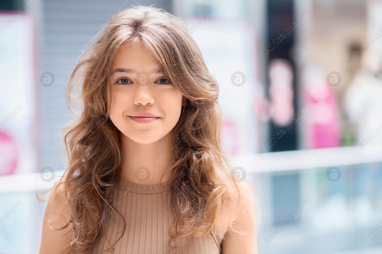 Photo of Portrait of beautiful teenage girl in shopping mall. Space for text