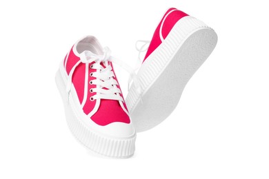 Photo of Pair of red classic old school sneakers on white background