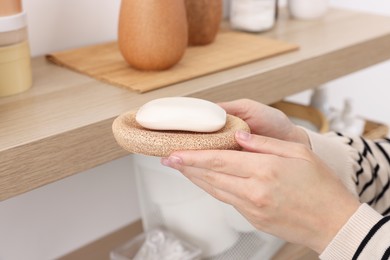 Photo of Bath accessories. Woman with soap indoors, closeup