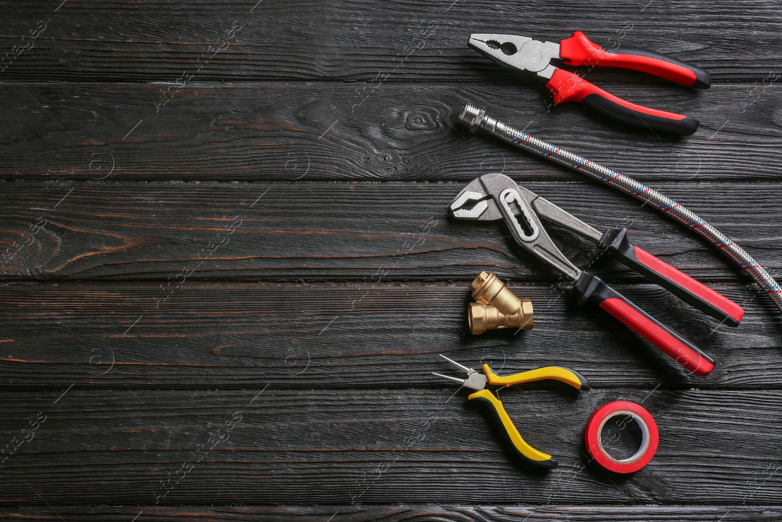 Photo of Flat lay composition with plumber's tools and space for text on wooden background