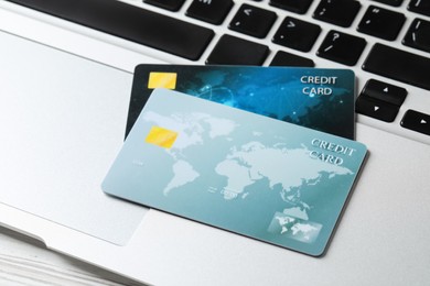 Photo of Online payment concept. Bank cards on laptop keyboard, closeup