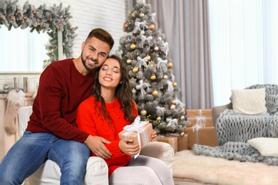 Image of Lovely couple celebrating Christmas together at home