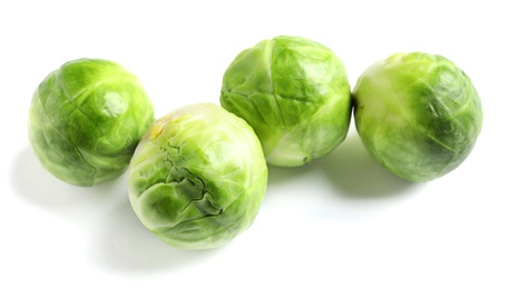 Fresh tasty Brussels sprouts on white background