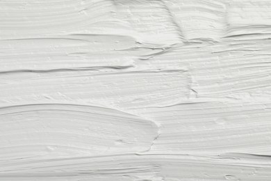 Photo of Texture of white oil paint as background, closeup