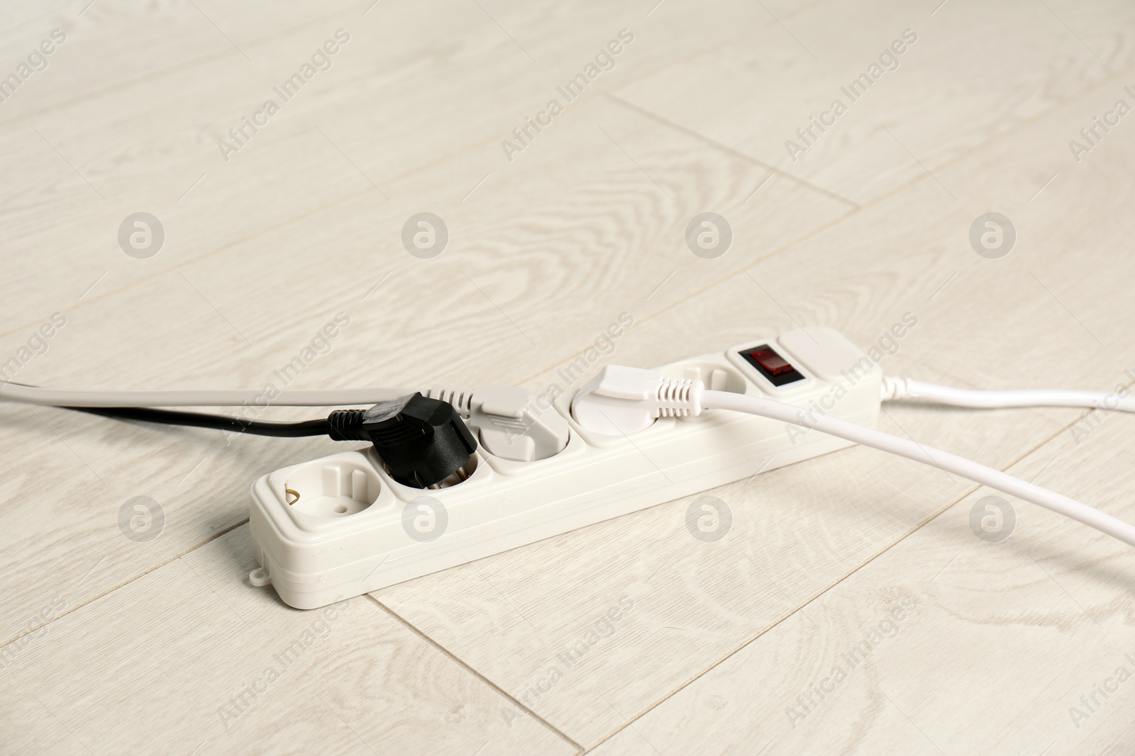 Photo of Extension cord on floor. Electrician's professional equipment