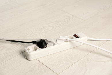 Photo of Extension cord on floor. Electrician's professional equipment